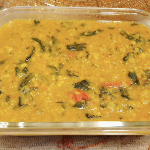 Spinach Tomato Dal (Lentil) Ingredients • Split Yellow Lentil (Mung Dal) 1/2 cup • Split Orange Lentil (masoor Dal) 1/2 cup • Clarified Butter (Desi Ghee) 2-3 tbsp • Onion 1 big, sliced • Ginger paste 1 tsp • Garlic paste 1 tsp • Green chilies 2 • Tomatoes 3 big, cut in big chunks • Red chili powder 3/4 tsp or to taste • Turmeric powder 1/2 tsp • Chicken cubes 2 • Salt to taste (chicken cubes also contain salt so add accordingly) • Spinach 2 cups, washed and drained. • Garam Masala 3/4 tsp • Cumin powder 1/2 tsp • Coriander powder 1 tsp Preparation 1. Wash and soak the lentils in water. 2. Meanwhile, heat Clarified Butter (Desi Ghee) in a pot and add sliced onions. Once translucent add ginger and garlic paste and green chilies. Cook until the raw smell goes off. 3. Now add chopped tomatoes, cover and cook until tomatoes are cooked. 4. Now add chicken cubes, red chili powder, turmeric powder and salt (if needed). 5. Cook for 1 minute until aromatic. 6. Add lentils and 3-4 cups of water. 7. Cover and allow to cook on low heat until the lentils are all cooked. 8. Now add spinach and cook for another 5-8 minutes until the spinach is blanched in the dal. 9. Lastly, add garam masala, coriander powder and cumin powder. Mix and turn of the flame and cover for 1 minute. 10. Serve hot with rice or roti. Enjoy! 11.